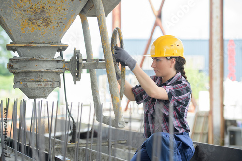 female woman mason working with cement outdoors photo