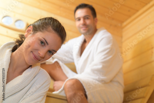 Фотография happy couple having a steam bath in a sauna