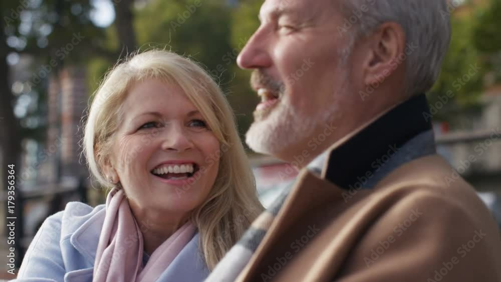 Happy mature couple talking whilst outside Happy mature couple talking whilst outside