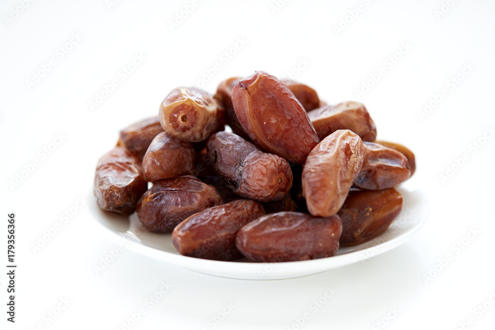 Dried Dates Fruits on dish white background Dried Dates Fruits on dish white background