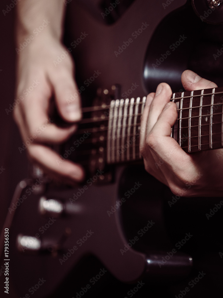 Fototapeta premium Male hands playing electric guitar