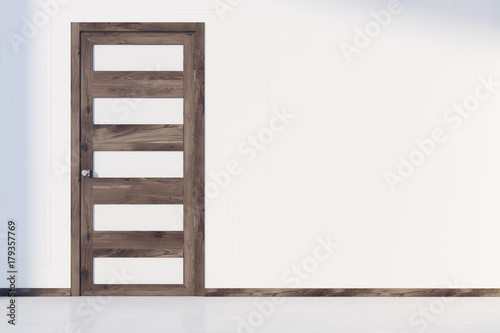Closed white and wooden door in a room