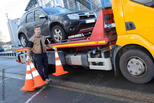 towing truck driver removing road signs photo