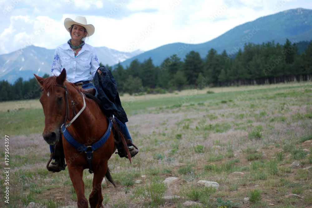Middle-Aged Cowgirl on Brown Horse Middle-Aged Cowgirl on Brown Horse