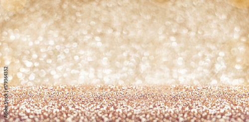 Abstract gold floor and wall glitter blur background studio room with bokeh lights,Sparkling backdrop banner for display or montage of product in holiday seasonal concept.