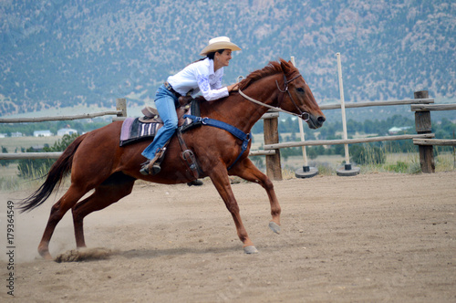 Middle-Aged Cowgirl on Brown Horse