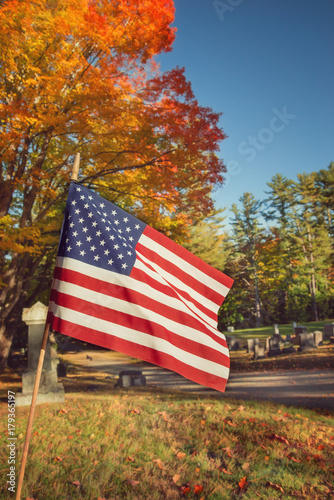 American veteran flag in autumn cemetery