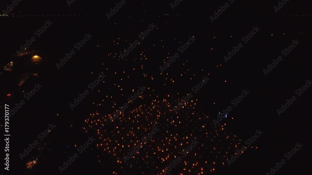 aerial light fest 100s of lanterns take to sky descending tilt close 4k