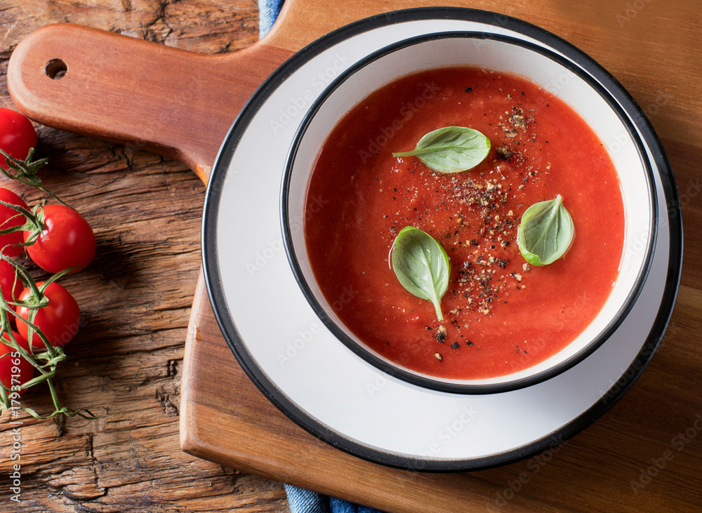 Tomato soup on a rustic wooden table Tomato soup on a rustic wooden table