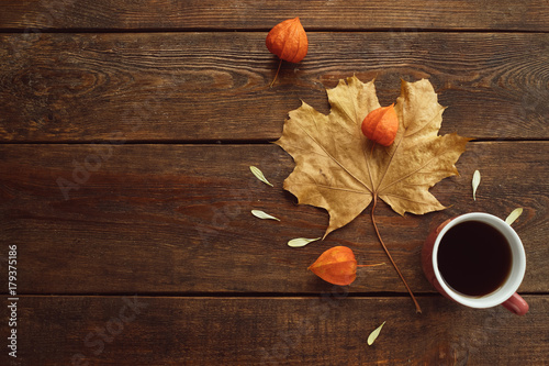  autumn coffee or tea warm maple leaf wooden surface background concept. Seasonal coziness. Disease prevention