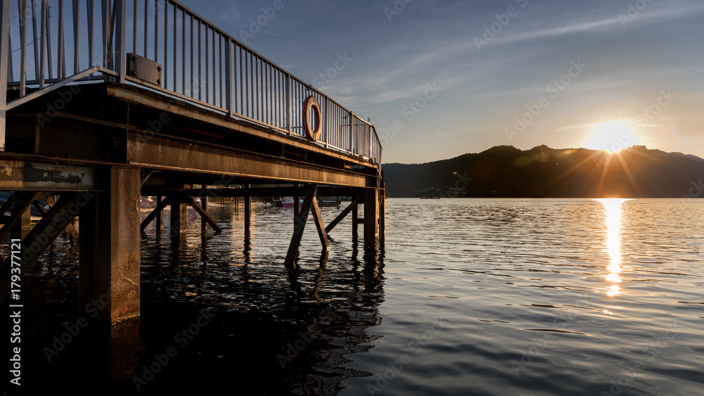 Dock at Lake and Mountain at Sunset or Sunrise