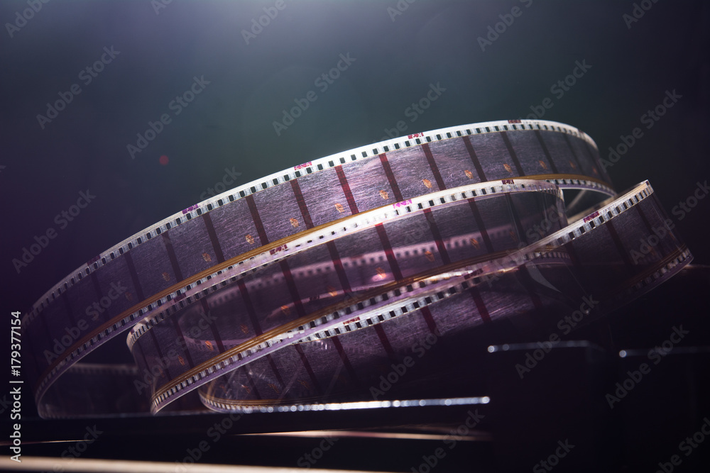 Fototapeta premium Old film with a movie on a dark background