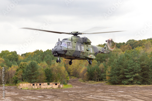 german military helicopter in flights over battlefield