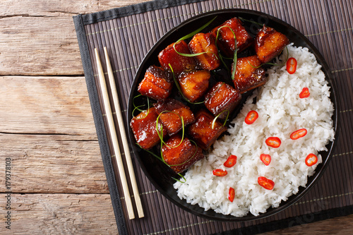 Vietnamese spicy caramel pork belly with rice closeup on a table. Horizontal top view
