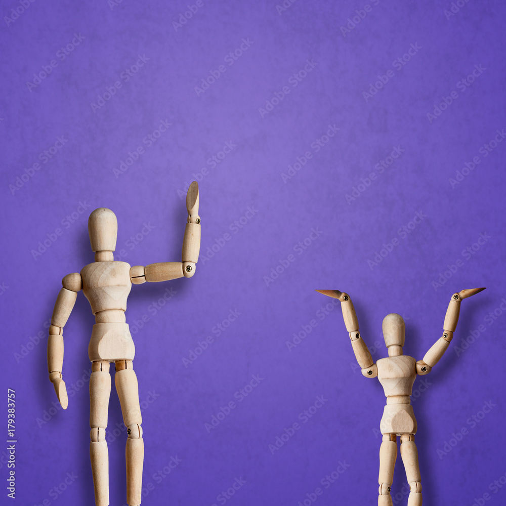 Two Wooden Mannequin wave hand with greeting on purple background Two Wooden Mannequin wave hand with greeting on purple background