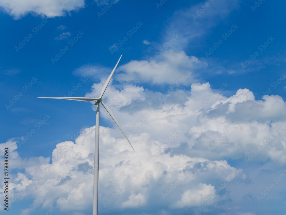 Wind turbine with blue sky and white clouds background. Wind turbine with blue sky and white clouds background.