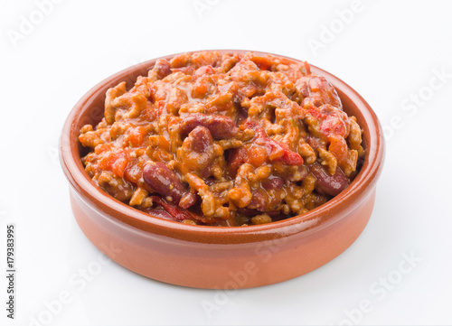 homemade stew of beans and meat in clay pot on white background