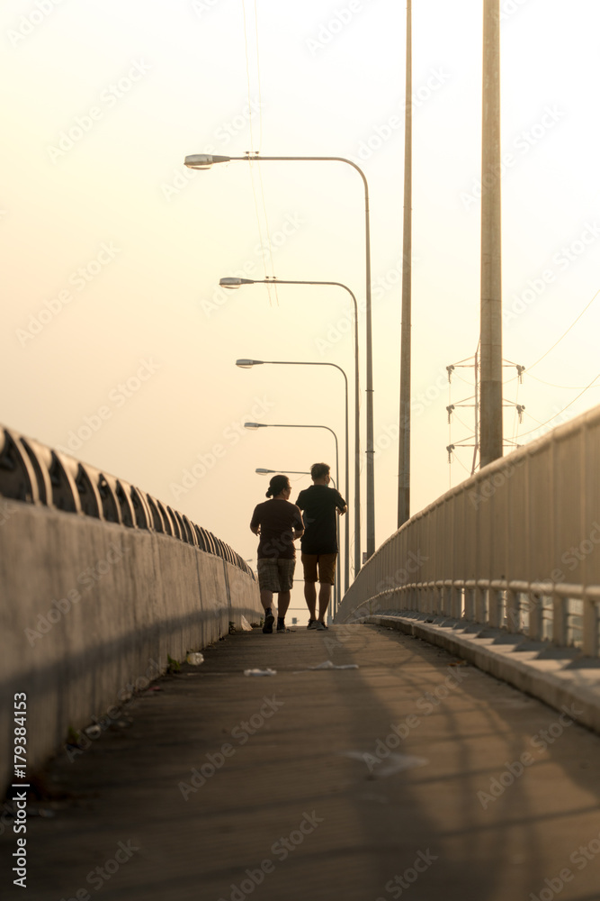 couple walk on  bridge Silluated