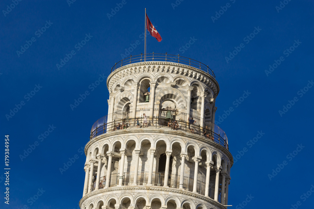 The top of the Pisa Tower with flag