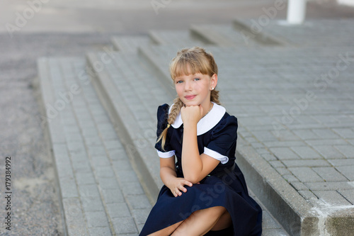 Portrait of a beautiful girl in a school uniform before class at school photo