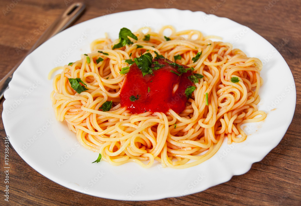 Pasta spaghetti with tomato sauce on white plate. on a wooden background. Pasta spaghetti with tomato sauce on white plate. on a wooden background.