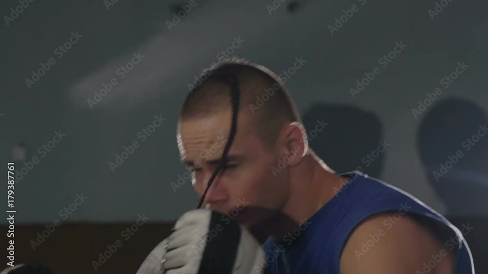 Close-up young male athletes training in boxing gym. Slowly Close-up young male athletes training in boxing gym. Slowly