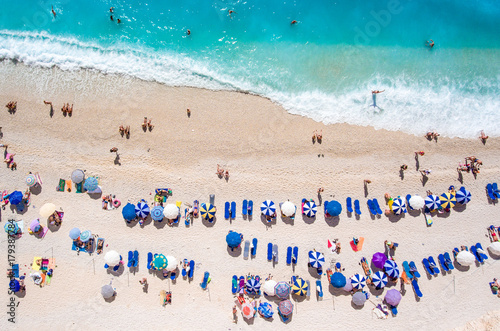 Egremni Beach Lefkada tourists relaxing on the beach, swimming and playing games on a hot summer day © Calin Stan