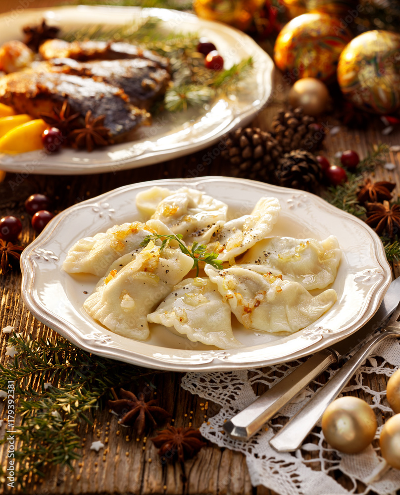 Christmas dumplings stuffed with mushroom and cabbage on a white plate. Traditional Cristmas eve dish in Poland