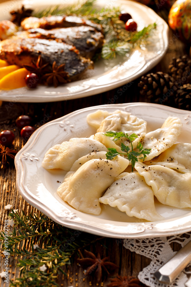 Christmas dumplings stuffed with mushroom and cabbage on a white plate. Traditional Cristmas eve dish in Poland Christmas dumplings stuffed with mushroom and cabbage on a white plate. Traditional Cristmas eve dish in Poland
