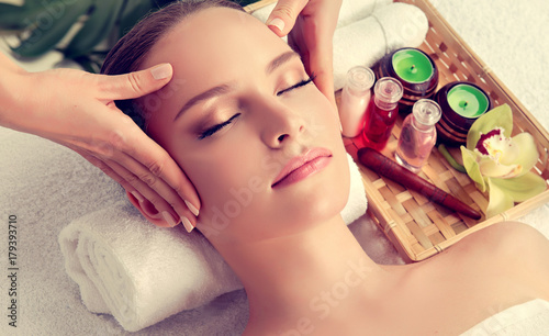 Massage and body care. Spa body massage treatment. Woman having massage in the spa salon for beautiful girl . Headache relief .massage woman hands