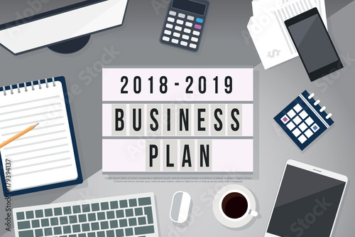 2018 to 2019 business plan on office table with computer, coffee, notepad, smartphone, calculator and digital tablet on table. top view