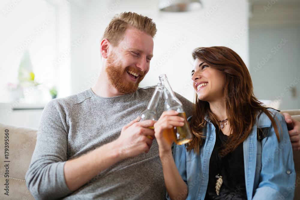Young beautiful couple flirting and smiling at home