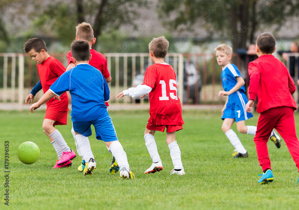 Young children players football match on soccer field