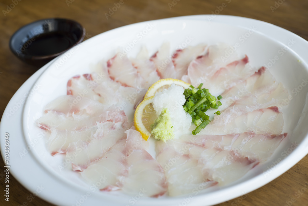 Kampachi sashimi with Shoyu sauce, Japanese cuisine.
Kampachi sashimi with Shoyu sauce, Japanese cuisine.