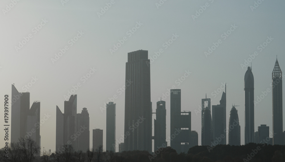 Architectural background with silhouettes of tall buildings.  Dubai. In the summer of 2016.
