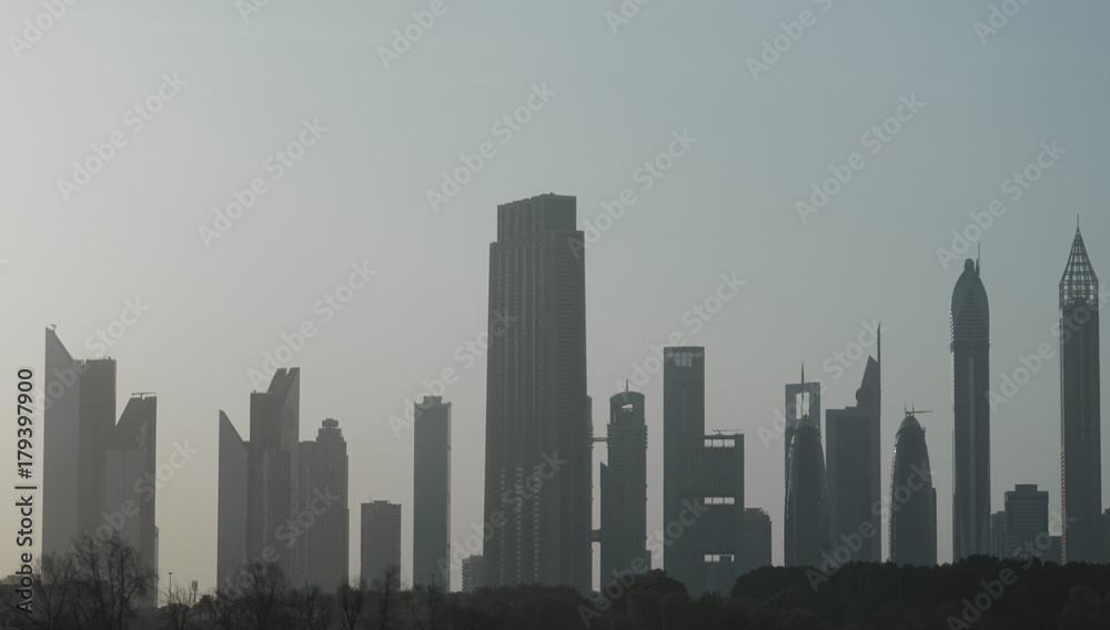 Architectural background with silhouettes of tall buildings. Dubai. In the summer of 2016.
Architectural background with silhouettes of tall buildings. Dubai. In the summer of 2016.