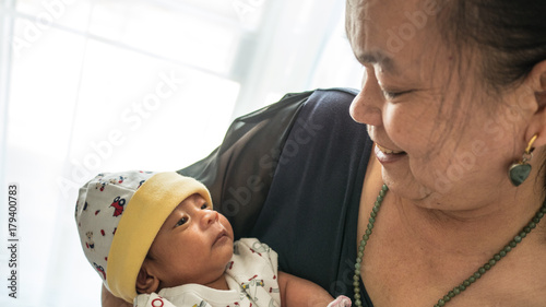 Newborn baby and grand mother