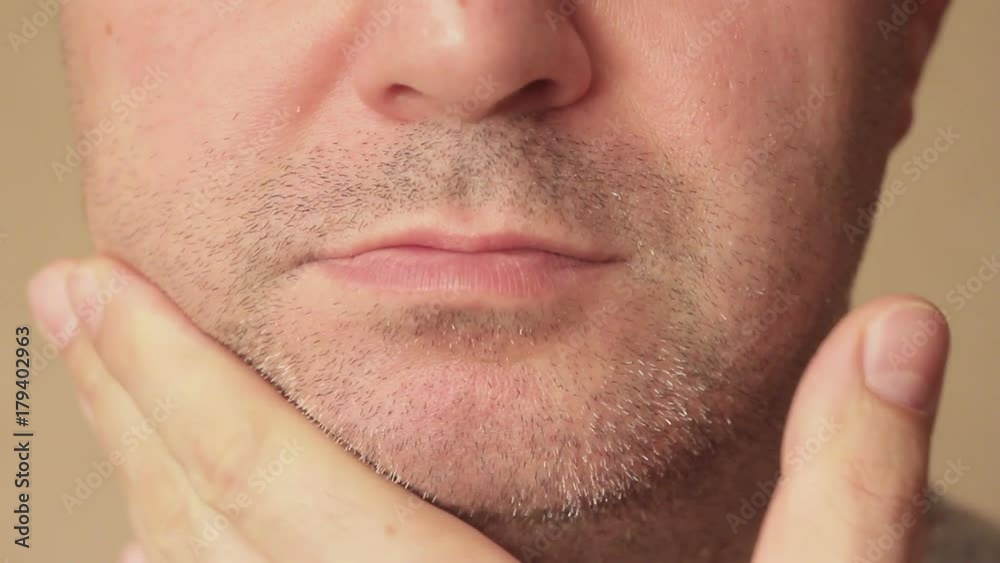 Close-up unshaven face of a man with a three-day stubble Close-up unshaven face of a man with a three-day stubble