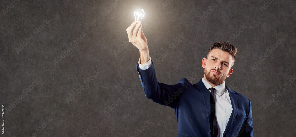 Businessman with luminous light bulb in hand on copyspase background. Businessman with luminous light bulb in hand on copyspase background.