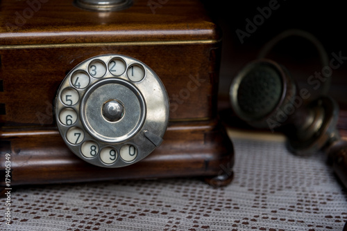 Old fashioned wooden telephone on table top, retro styled 