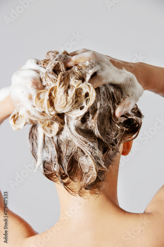 Woman washing her blond hair