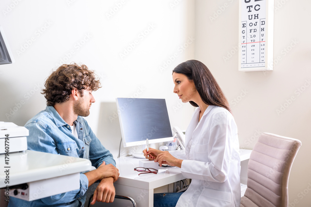 A Doctor writing a prescription in the Consultation room A Doctor writing a prescription in the Consultation room