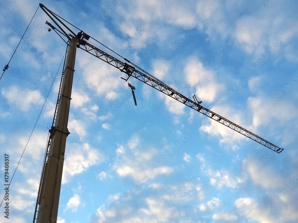 construction crane against blue and white sky