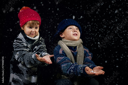 Happy children playing with snowflakes on winter walk.Happy Christmas holidays