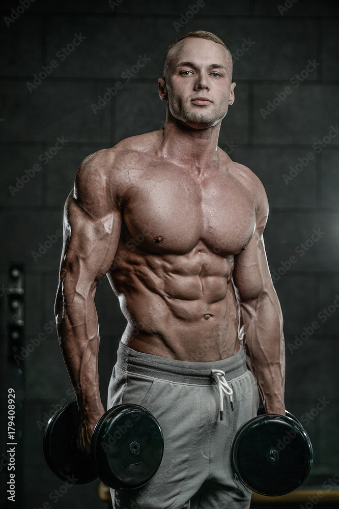 Handsome model young man training abs in gym Handsome model young man training abs in gym