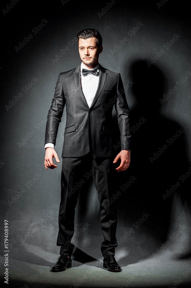 portrait of confident handsome man in black suit with bowtie portrait of confident handsome man in black suit with bowtie