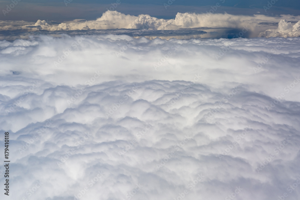 The top view on clouds from an airplane window The top view on clouds from an airplane window