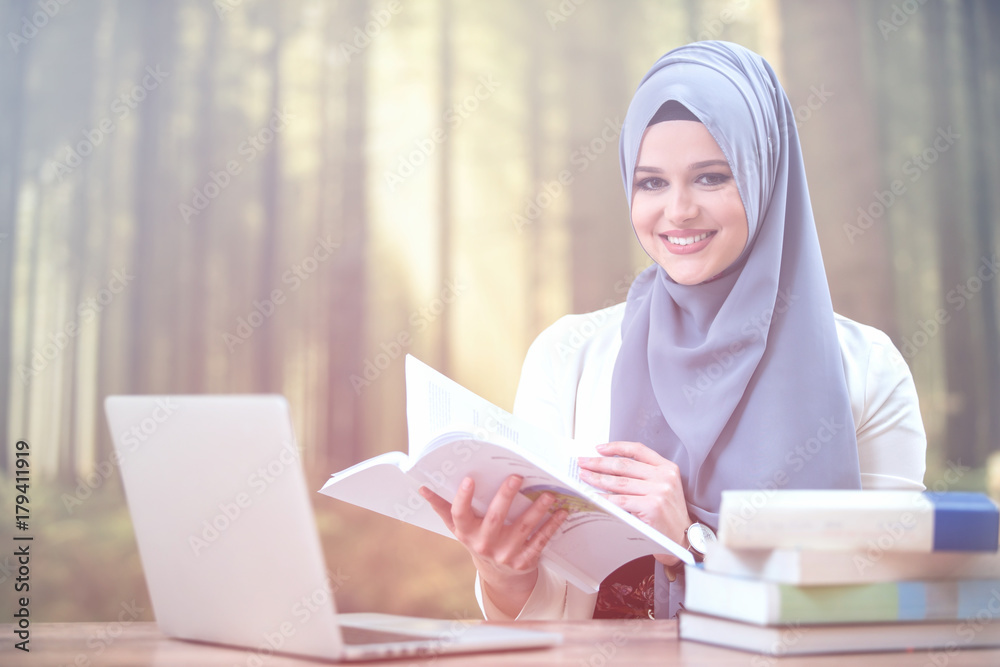 Pretty woman wearing hijab in front of laptop Pretty woman wearing hijab in front of laptop