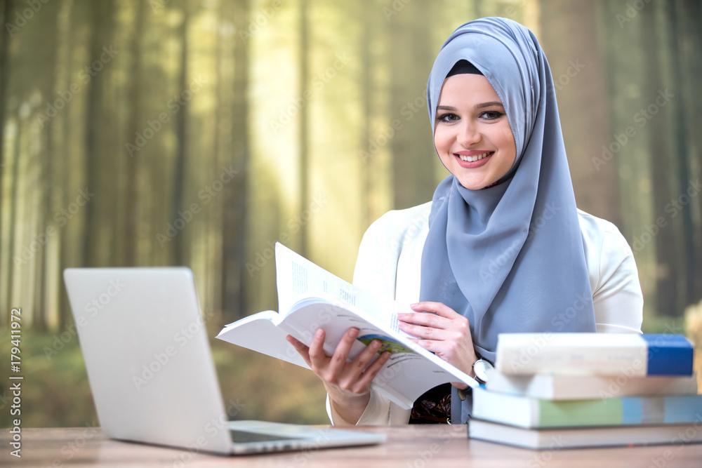 Pretty woman wearing hijab in front of laptop Pretty woman wearing hijab in front of laptop
