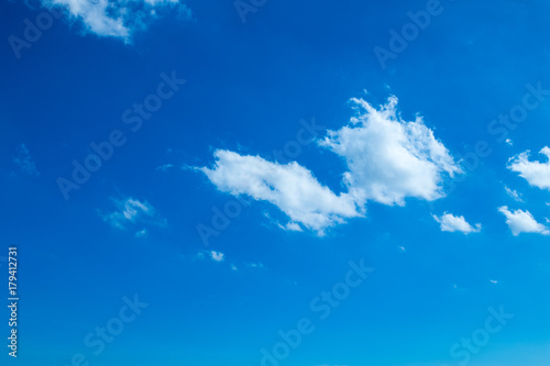 Brilliant blue sky background with a tiny clouds in daylight.